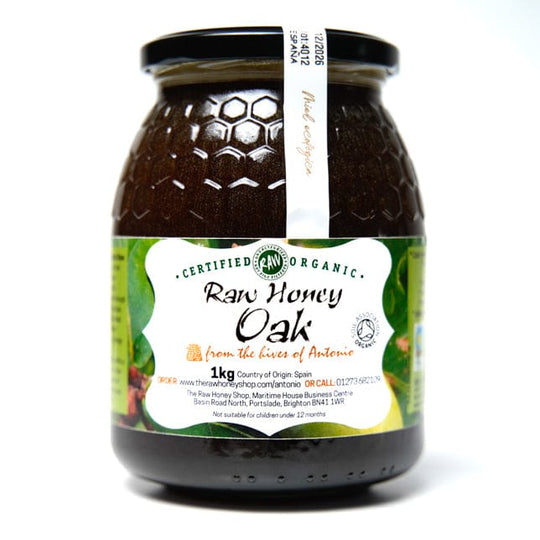 Glass jar containing 1kg of raw organic oak honey