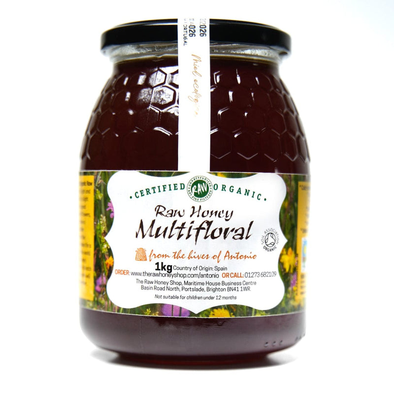 Glass jar containing 1kg or raw organic multifloral honey