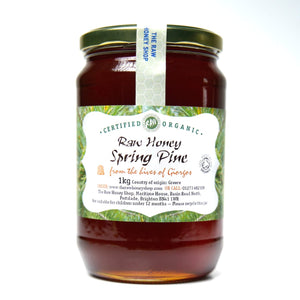 Large labelled glass jar containing 1kg of dark raw organic spring pine honey.