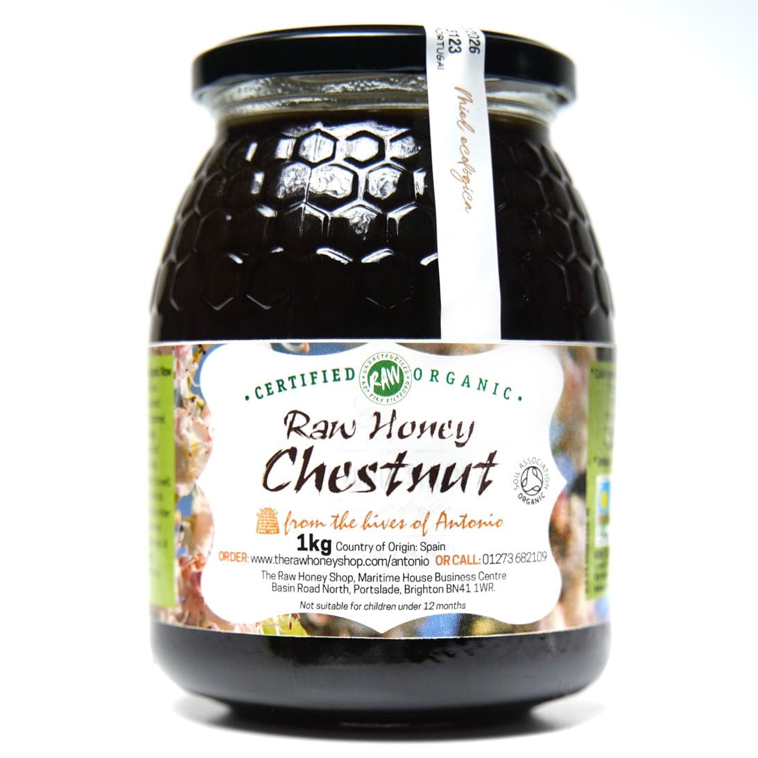 Glass jar containing 1kg of dark raw orgainc chesnut honey