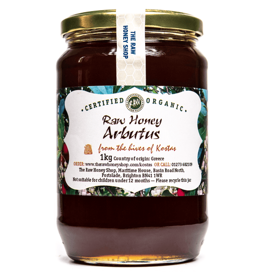 Large labelled glass jar containing 1kg of dark raw organic arbutus honey.