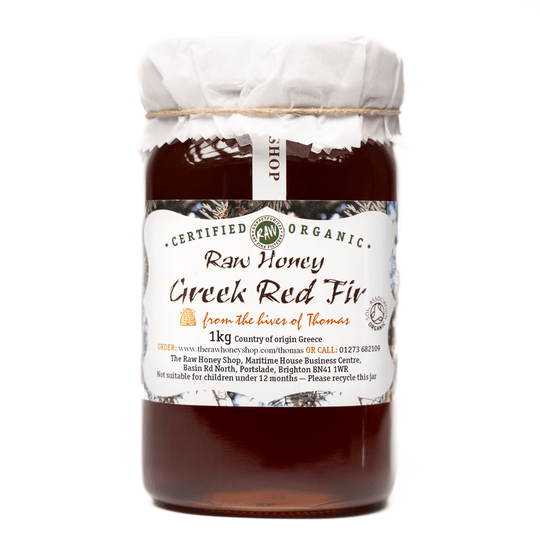 Large labelled glass jar containing 1kg of dark raw organic Greek red fir honey