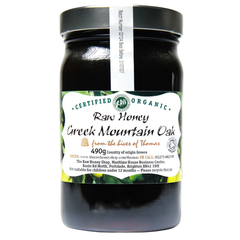 Labelled glass jar containing 490g of dark raw organic Greek mountain oak honey