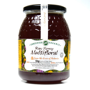 Large glass jar containing 1kg of dark raw organic multifloral honey