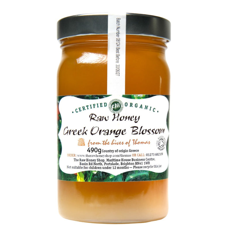 Labelled glass jar containing 490g of  raw organic Greek orange blossom honey.