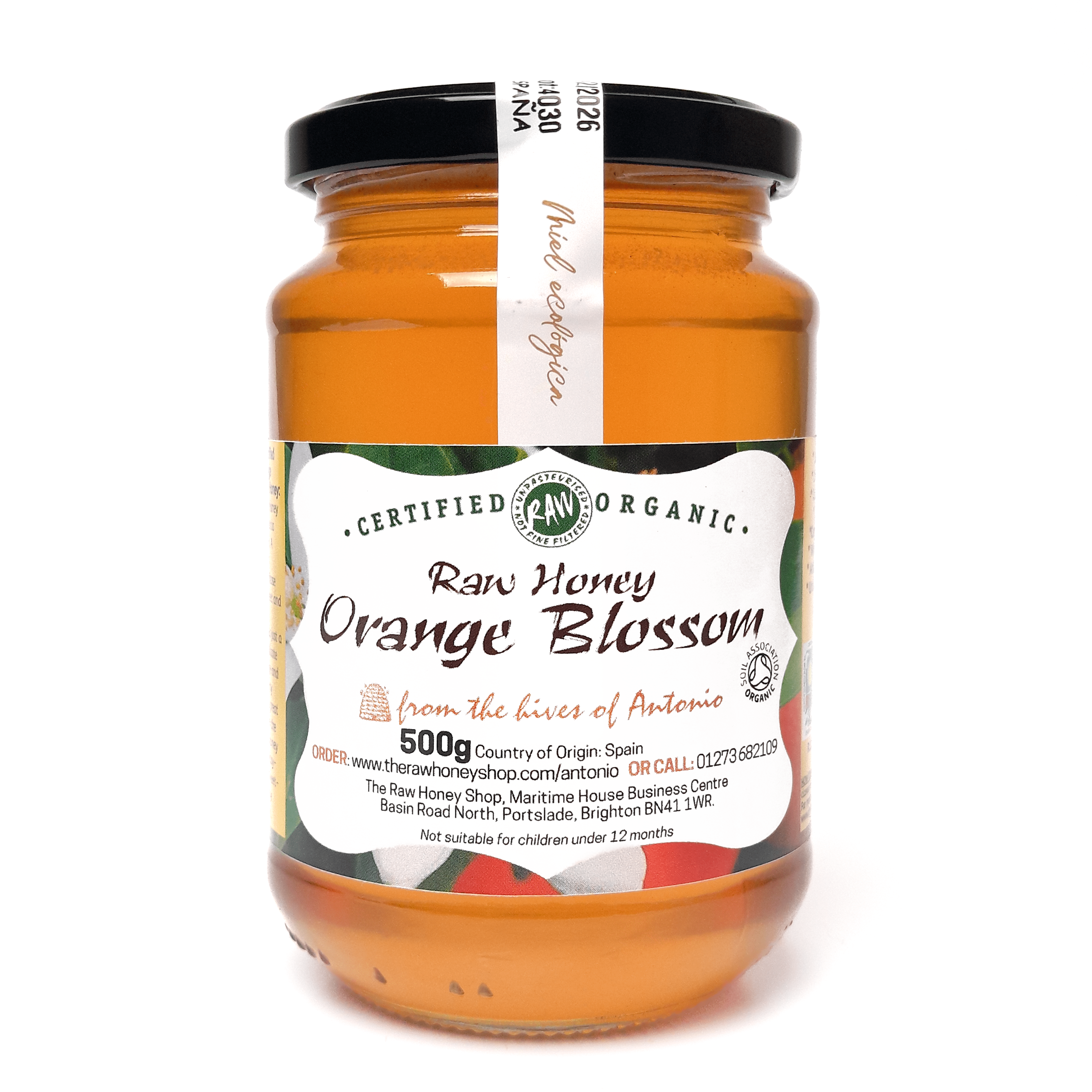 Glass jar containing 500g of raw organic orange blossom honey