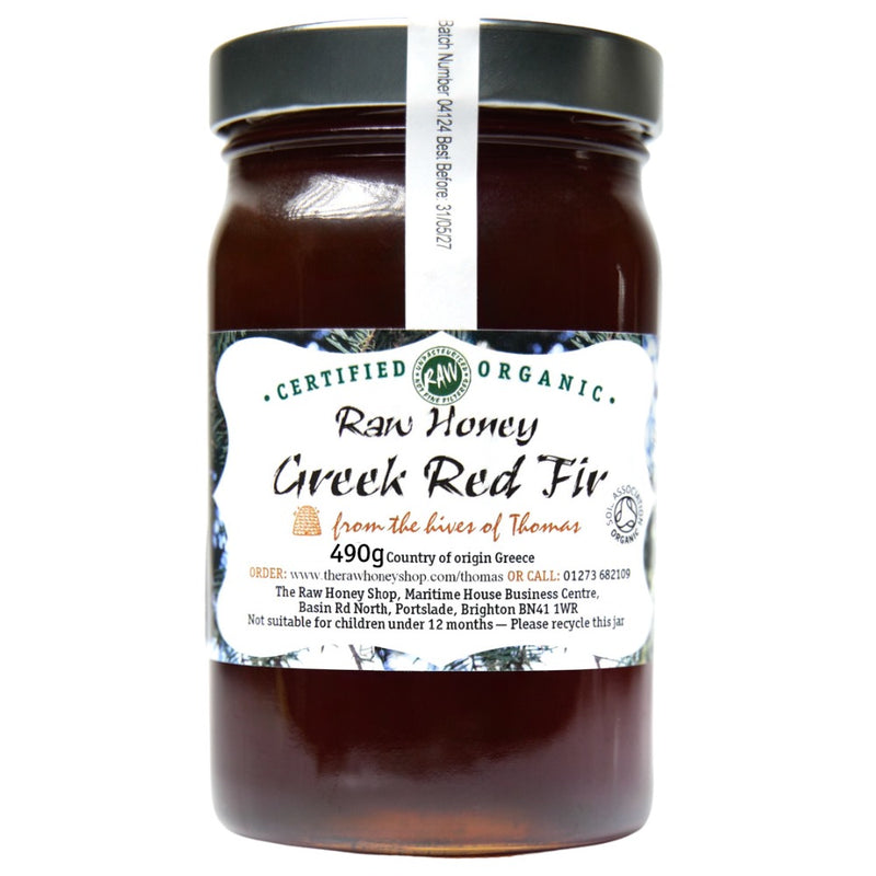 Labelled glass jar containing 490g of dark raw organic Greek red fir honey.