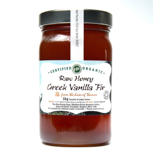 Large labelled glass jar containing 1kg of dark raw organic Greek vanilla fir honey