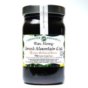 Large labelled glass jar containing 1kg of dark raw organic Greek mountain oak honey.