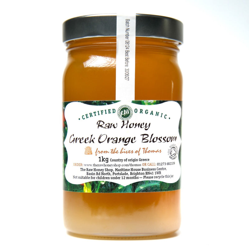 Large labelled glass jar containing 1kg of raw organic Greek orange blossom honey.