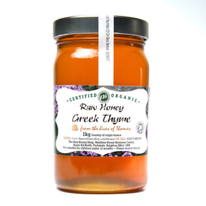 Large labelled glass jar containing 1kg of raw organic greek thyme honey.