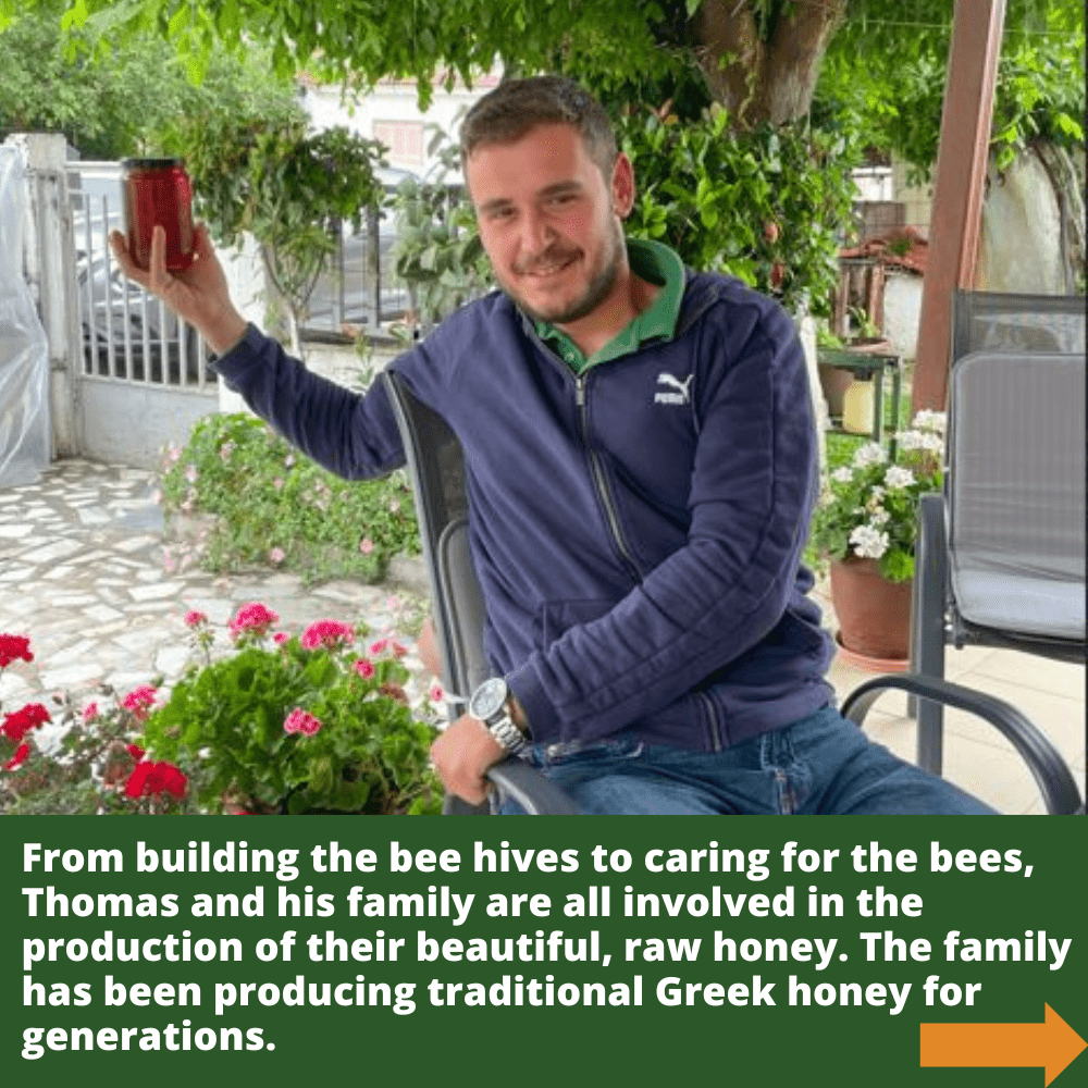 Beekeeper Thomas sitting in courtyard with flowers holding jar of raw honey.