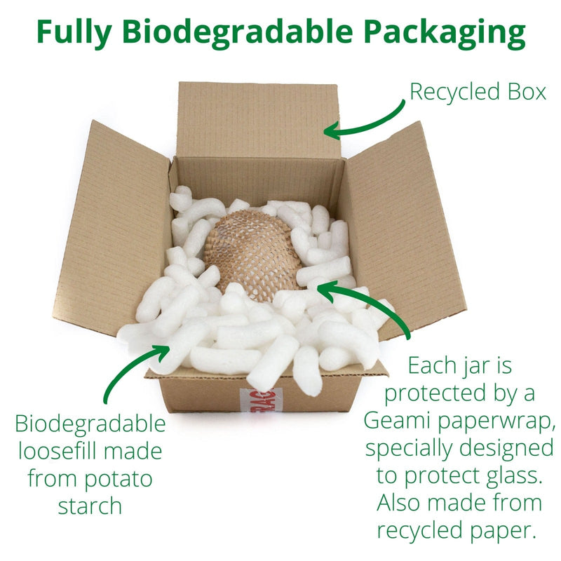 open cardboard box with wrapped jar of honey and biodegradable loosefill made from potato starch inside.