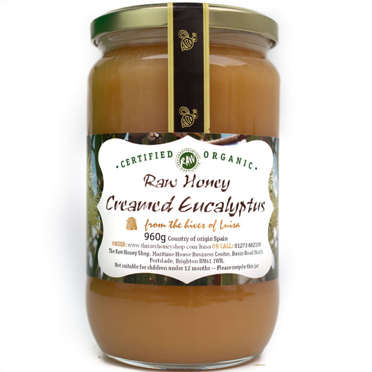 Large glass jar containing 960g of toffee coloured raw organic eucalyptus creamed honey