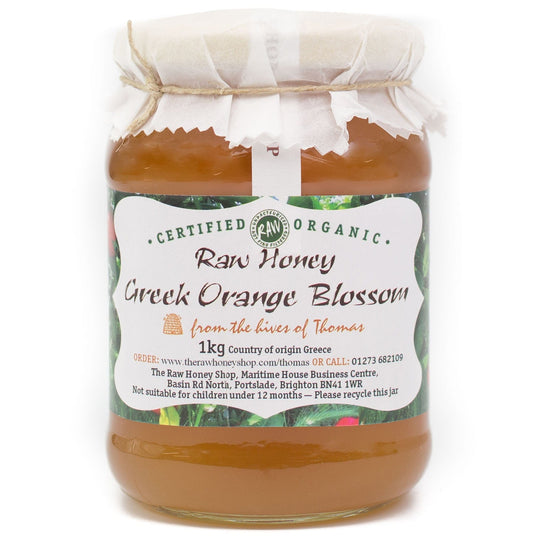 Large labelled glass jar containing 1kg of raw organic Greek orange blossom honey.